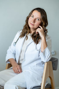 Portrait of smiling young woman sitting at home