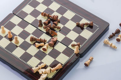 High angle view of chess board over white background