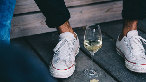 Low section of man with wine bottles