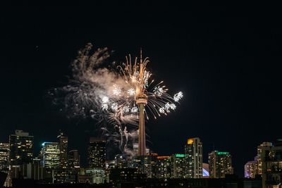 Low angle view of firework display against sky at night