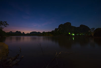 Scenic view of lake against sky at night