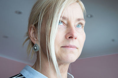 Mature woman looking away at home