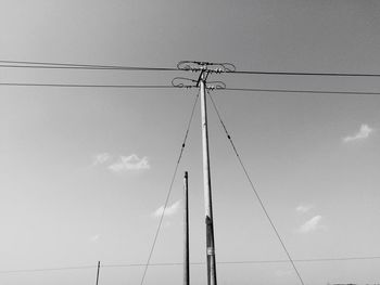 Low angle view of electricity pylon against sky