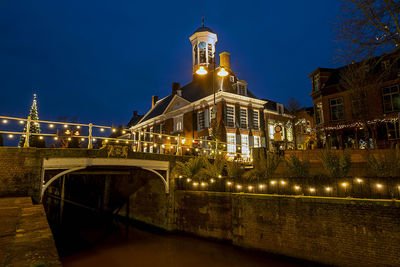Medieval city hall from dokkum in the netherlands at twiligt in christmas time