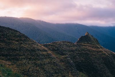 Scenic view of mountains against cloudy sky