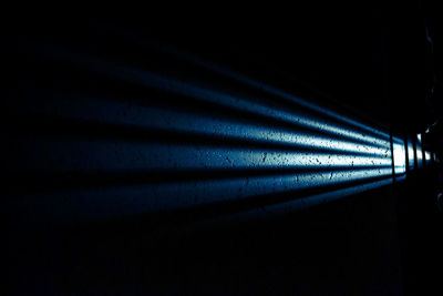 Close-up of illuminated lighting equipment in dark room