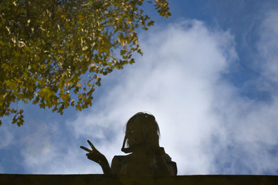 Low angle view of statue against sky