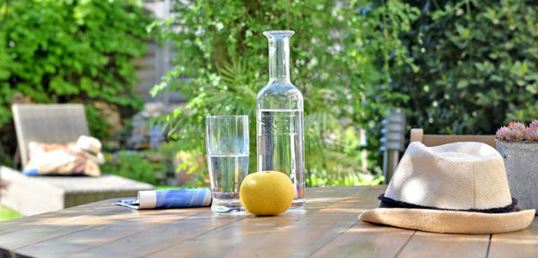 Drink on table against plants