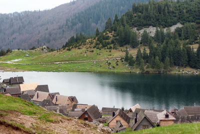 Scenic view of lake and trees against mountains