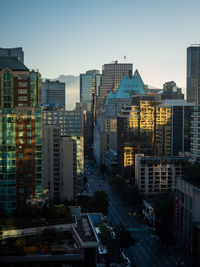 Buildings in city against clear sky