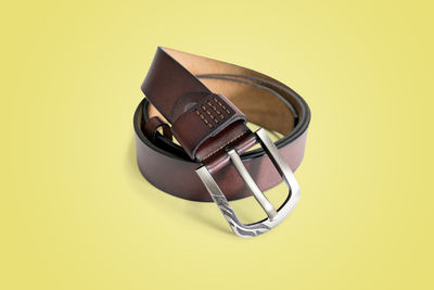 Brown fashion leather belt isolated on pastel color background with clipping path.