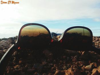 View of rocks against cloudy sky