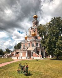 Traditional building by trees against sky