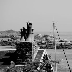 Built structure by sea against clear sky