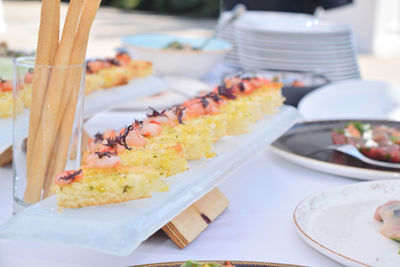 Triangular croutons garnished with smoked salmon and various spices