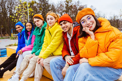 Portrait of friends sitting on snow