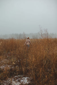 Man standing on field against sky