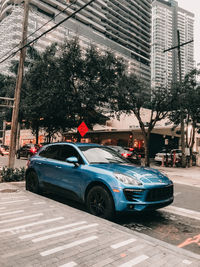 Cars on street by buildings in city