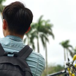 Rear view of backpack man against clear sky