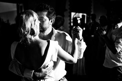 Close-up of couple dancing in party