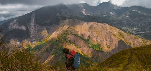 Rear view of woman walking on mountain