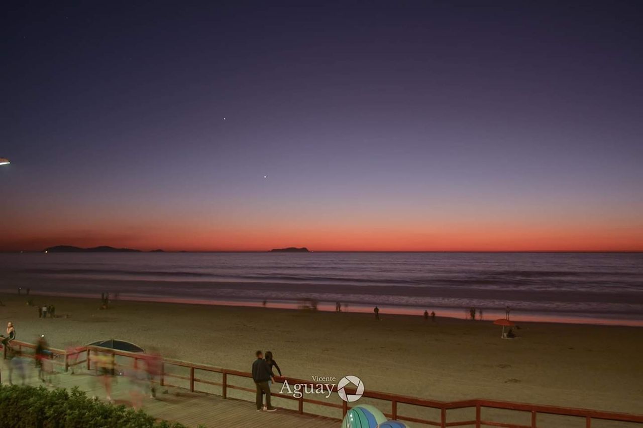 sky, water, land, beauty in nature, horizon, beach, real people, sea, nature, horizon over water, people, leisure activity, scenics - nature, lifestyles, sunset, men, copy space, railing, dusk, outdoors, riding