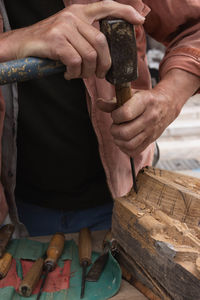 Cropped hands of man working at workshop