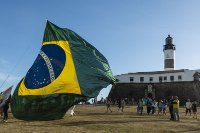 Supporters of the president of brazil jair bolsonaro, place a large brazilian flag 