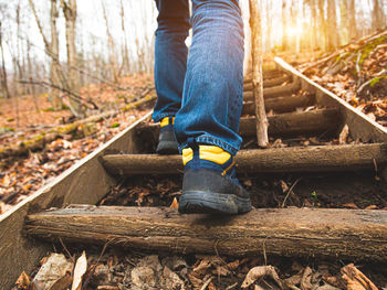 Low section of man standing on railroad track