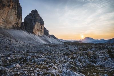 Scenic view of rocky mountains against sky during sunset