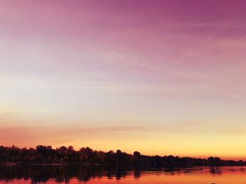 Scenic view of lake against romantic sky at sunset