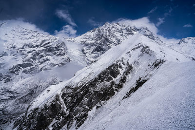 Scenic view of snow covered mountains against sky