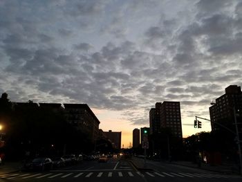 Railroad tracks against cloudy sky