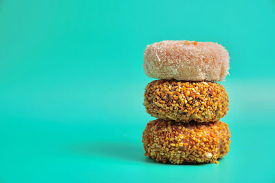 Close-up of stack on table against blue background