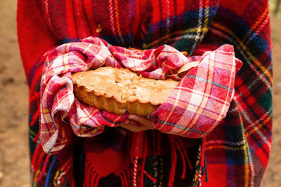 Midsection of man holding red chili peppers