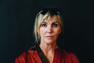 Portrait of woman against black background