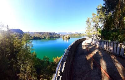 Scenic view of river against clear blue sky