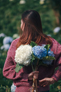 Midsection of woman holding bouquet