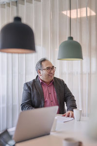 Smiling man in office looking away