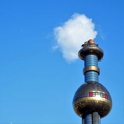 Low angle view of lighthouse on building against sky