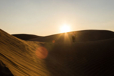 Scenic view of desert against sky during sunset