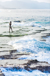 Rear view of man swimming in sea