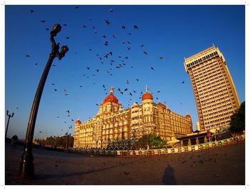 View of buildings against clear blue sky