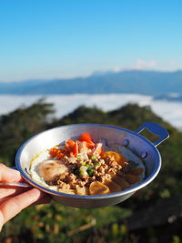 Cropped hand of person holding food