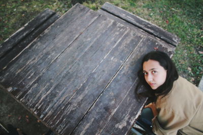 Portrait of man standing on bench