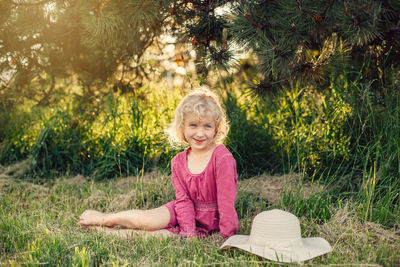 Portrait of a smiling girl sitting on grass