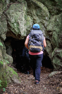 Rear view full length of woman entering cave