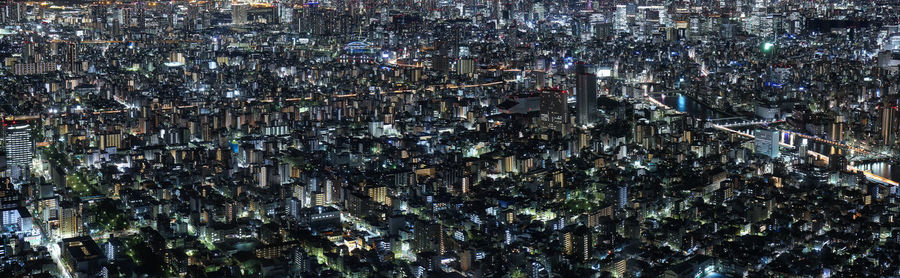 High angle view of city lit up at night