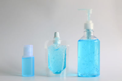 Close-up of bottles against blue background