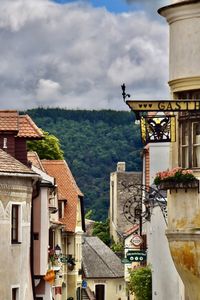 Buildings in town against sky